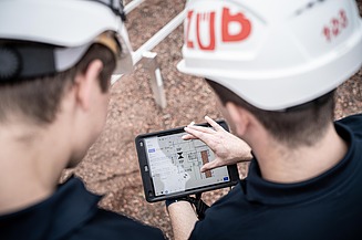 Zwei STRABAG Baustellenmitarbeiter Zu sehen sind zwei STRABAG Baustellenmitarbeiter die sich über Sanierung und Umbau einer Bestandsimmobilie unterhalten